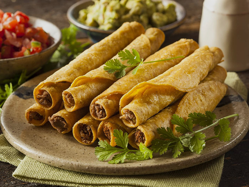 a plate of taquitos